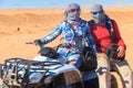 Young couple in safari trip through egyptian desert driving ATV. Quad bikes safari in desert near Hurghada, Egypt