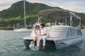 Young couple is sailing on a yacht in the Indian ocean. Man and woman sit on the edge of the yacht. Royalty Free Stock Photo