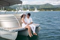 Young couple is sailing on a yacht in the Indian ocean. Man and woman sit on the edge of the yacht. Royalty Free Stock Photo