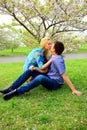 Young couple in the sakura's garden in park