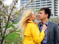 Young couple in the sakura's garden in park