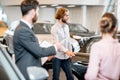 Couple choosing a new car in the showroom Royalty Free Stock Photo