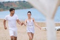Young couple on sand seashore in cloudy day Royalty Free Stock Photo