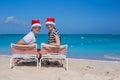 Young couple in Santa hats during beach vacation