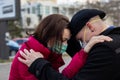 Young couple saying goodbye wearing masks to protect them from viruses, smog, and other atmospheric pollutants. Royalty Free Stock Photo