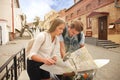 Young Couple with scooter looking at map. Royalty Free Stock Photo
