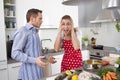 Young couple screaming at home in the kitchen. Royalty Free Stock Photo