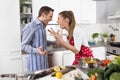 Young couple screaming at home in the kitchen. Royalty Free Stock Photo