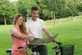 Young couple searching the direction during a bicycle tour