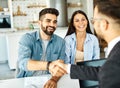 young couple shaking hands deal contract real estate investment business agreement agent handshake signing Royalty Free Stock Photo