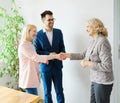 young couple shaking hands deal contract real estate investment business agreement agent handshake signing Royalty Free Stock Photo