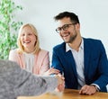 young couple shaking hands deal contract real estate investment business agreement agent handshake signing Royalty Free Stock Photo