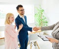 young couple shaking hands deal contract real estate investment business agreement agent handshake signing Royalty Free Stock Photo