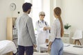 Young couple shaking hands with smiling family practitioner or pregnancy specialist Royalty Free Stock Photo