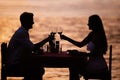 Couple sharing romantic sunset dinner on the beach Royalty Free Stock Photo