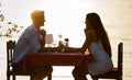 Couple sharing romantic sunset dinner on the beach Royalty Free Stock Photo