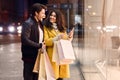 Young couple with shopping bags and smartphone near mall Royalty Free Stock Photo