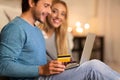 Young Couple Shopping Online Using Laptop And Credit Card At Home Royalty Free Stock Photo