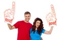 Young couple showing boo hurray foam hand Royalty Free Stock Photo