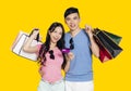 Young couple showing credit card  and  shopping bags Royalty Free Stock Photo