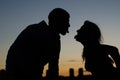 Young couple showing each other tongue against the evening city Royalty Free Stock Photo