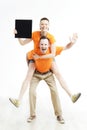 Young couple with sign they are holding against a white background. Royalty Free Stock Photo