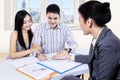 Young couple signing financial contract