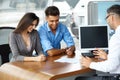 Young Couple Signs a Contract For the Purchase of a New Car Royalty Free Stock Photo