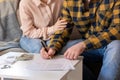 Young couple signs documents of renting or purchase real estate. Loan and mortgage concept Royalty Free Stock Photo