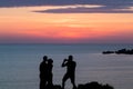 Young couple silhouetted watching a romantic beautiful golden su