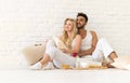 Young Couple Sit On Pillows Floor, Happy Hispanic Man And Woman Breakfast Tray Lovers In Bedroom Royalty Free Stock Photo