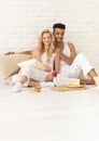 Young Couple Sit On Pillows Floor, Happy Hispanic Man And Woman Breakfast Tray Lovers In Bedroom Royalty Free Stock Photo