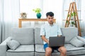 A young couple sits on a sofa in the living room with a pregnant woman and a man holding a folder in his hand, a life insurance Royalty Free Stock Photo