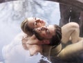 young couple sitting in a tub filled with water Royalty Free Stock Photo