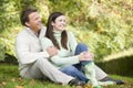 Young couple sitting in autumn woods Royalty Free Stock Photo