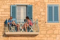 Young couple sitting on the balcony of the Mediterranean house