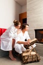 Young couple sitting in bathrobe for fire Royalty Free Stock Photo