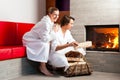 Young couple sitting in bathrobe for fire Royalty Free Stock Photo