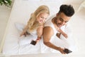 Young Couple Sitting In Bed, Happy Smile Hispanic Man And Woman Using Cell Smart Phone Royalty Free Stock Photo