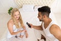 Young Couple Sitting In Bed, Happy Smile Hispanic Man And Woman Using Cell Smart Phone Royalty Free Stock Photo