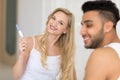 Young Couple Sitting In Bed, Happy Smile Woman Show Excited Surprised Man Positive Pregnancy Test Royalty Free Stock Photo