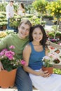 Young couple sitting on bench in garden centre Royalty Free Stock Photo