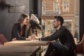 Young couple sitting caffee shop indoors, holding hands Royalty Free Stock Photo