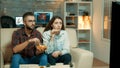 Young couple sitting on the couch and watching television Royalty Free Stock Photo