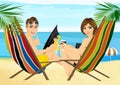 Young couple sitting in deck chairs on the beach toasting Royalty Free Stock Photo