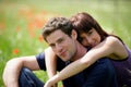 Young couple sitting in a field Royalty Free Stock Photo
