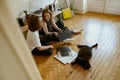 Young couple sitting on floor and listening music on vinyl player with different vinyl records Royalty Free Stock Photo