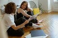 Young couple sitting on floor and listening music on vinyl player with different vinyl records Royalty Free Stock Photo