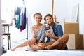 Young couple sitting on the floor moving in new house. Royalty Free Stock Photo