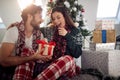 A young couple sitting on the floor surrounded by Xmas presents. Christmas, relationship, love, together Royalty Free Stock Photo